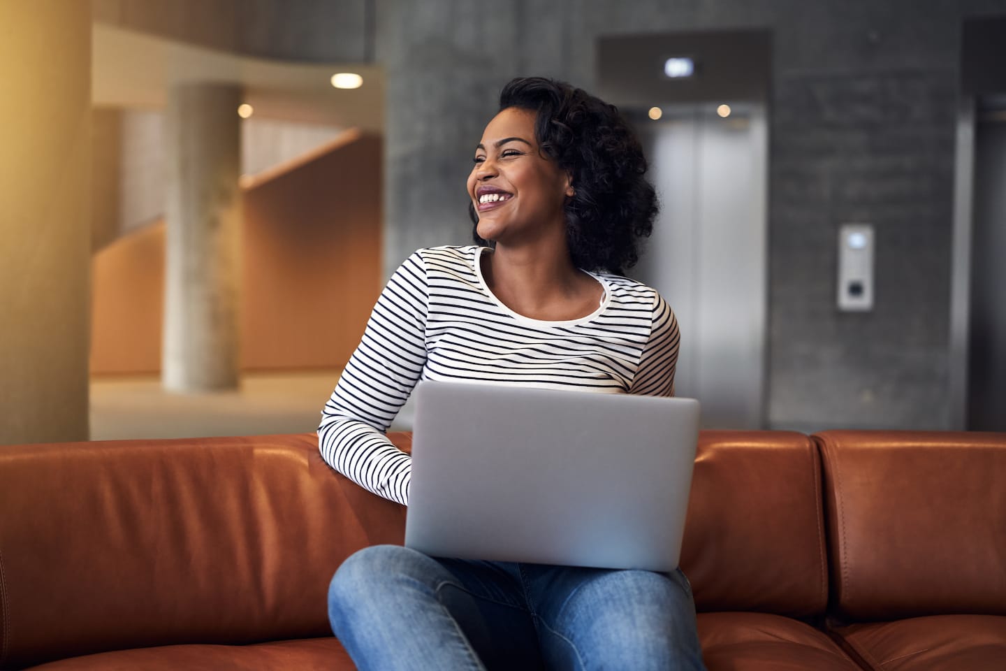 smiling-african-college-student-sitting-on-a-TASD5BV